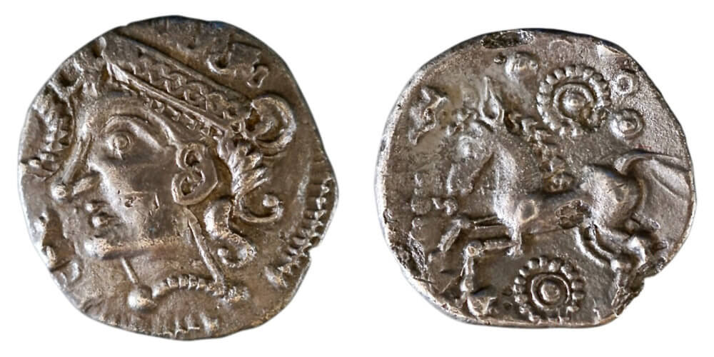 East Anglian, Iceni, c. 55-50 BCE, uninscribed silver unit (ABC-; Talbot Bury A, dies E/17).With some similarities to the first coin, the obverse shows a female head, with a long-pointed nose, a heart-shaped ear, a lunar crown and beaded neck-torc. In this case, we have a snake (only partially revealed in this example) rather than duck, possibly indicating the healing goddess, Sirona or the goddess of war Andraste. The ever-dramatic Dio Cassius has Boudica invoking Andraste before battle, by revealing a hare from her dress, more than a century after this coin. Wright, Coin 102. 