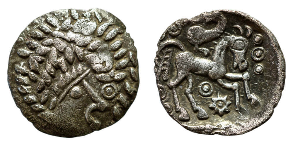 Southern, Regini, c. 55-45 BCE, uninscribed silver unit (ABC 659).Strabo and Caesar described Britons as nomadic herdsmen, living off the milk and meat of their livestock, while in reality they lived in settled rural communities, sowing crops and were preoccupied with fertility and the seasons. This coin exudes a bounteous harvest, with corn-ears forming exuberant hair that practically eclipses the diminutive pellet-and-line face of what may be a corn-god. The reverse is another playful sun-horse, with similarities to the reverse of the third coin. Wright, Coin 30. 