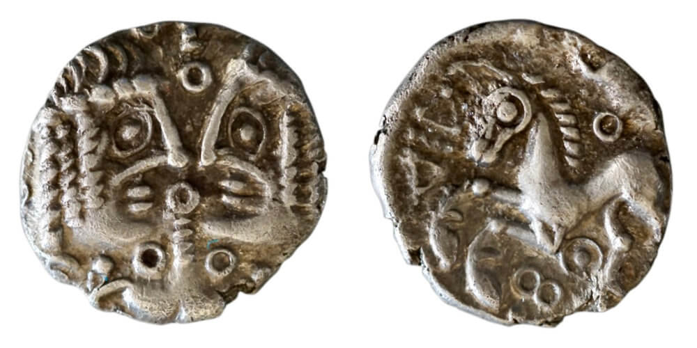 Kent, Cantiaci, c. 50-30 BCE, uninscribed silver unit (ABC 216).The defining feature of the next coin is a symmetrical design of two similar clean-shaven male heads, with beak-like noses, large eyes formed of ringed-pellets and line lips. The subject of twins is a Roman favourite, depicting the Dioscuri, the twins of Zeus, Castor and Pollux, the patrons of sports, war, and general good fortune. But here, the heads are facing rather than opposed (in the Janus head of the Dioscuri), and we have a bucranium (bull’s skull) below which reveals a hidden-face when rotated.. This original pre-Roman British coin became a prototype for an eighth century Anglo-Saxon sceatta. Wright, Coin 56. 