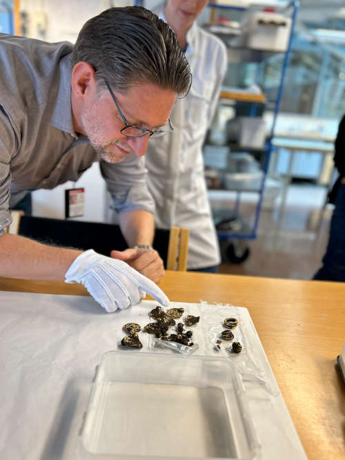 Professor Sigmund Oehrl at the Archaeological museum, University of Stavanger, checks the gold find that was delivered to the museum. © Anniken Celine Berger, The Museum of Archaeology, University of Stavanger.
