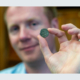 Professor Rory Naismith holding a Byzantine silver coin in the Fitzwilliam Museum. Photo: Adam Page.