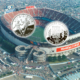 2026 soll die nächste Fußball-WM gemeinsam von den USA, Kanada und Mexiko ausgetragen werden. Hier eine der Dollar-Münzen, die auf die letzte WM in den USA 1994 herausgegeben wurden. Bild: US-Mint. Im Hintergrund das Giants-Stadion in New Jersey, einer der damaligen Austragungsorte. Foto: JazzyJoeyD / CC BY-SA 4.0.